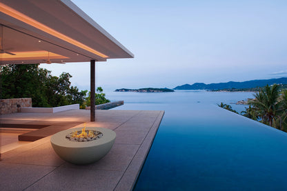 Outdoor infinity pool with fire pit and ocean view